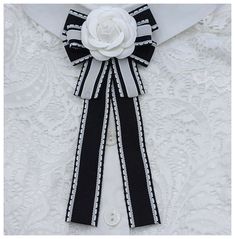 I offer an elegant women's tie! Made of black and white ribbon, decorated with a white rose made of fabric. On a pin. Handmade. Gift wrap. Chic White Formal Brooch, Formal White Bow, White Ribbon Brooches For Party, Formal White Bow Brooches, Formal White Bow Brooch, Formal White Brooch With Bow, Classic White Bow With Ribbon, Chic White Bow With Ribbon, Black And White Ribbon