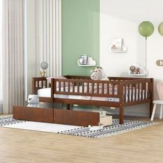 a baby's room with green walls and white furniture