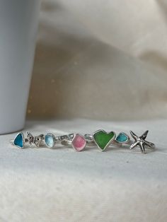 Variants 71-106 - please message me if you are interested in any of these.  Best seller, over 250 rings sold in 2023! We are a UK-based business and each ring is made to order. *One of kind Sea Glass ring, entirely handcrafted in sterling silver (.925) and fine silver (.999). *You have a chance to select the glass colour and shape. All options were found on Seaham Beach in the UK. *The length of most glasses is from 7 mm to 10 mm, and the width of most is from 5 mm to 8 mm.  *Select your size or Colourful Silver Jewelry, Seaham Beach, Memory Ring, Beach Jewellery, Ring Inspo, Sea Glass Ring, Green Beach, Open Rings, Popular Rings