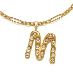 The Pearl Initial is a bestselling, original Sequin design, created in 22K gold-dipped brass with glass pearl accents, on our signature Figaro Link Chain, so unique! Vintage feel, statement look - the chicest way to make the personalization trend your own. Each letter design was sculpted by hand by our Creative Director, then cast using the ancient lost wax method, a time-honored technique practiced by master craftsmen. Initial Talismans give you so many options to add to your neck game. Whether The Letter M, Talisman Necklace, Sequin Design, Letter Design, Letter M, Gold Dipped, Pearl Choker, The Pearl, 22k Gold