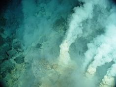 an aerial view of steam rising from the water