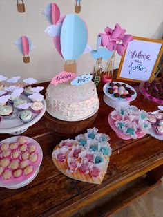 a table topped with lots of cakes and desserts