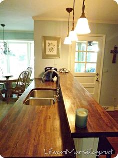 a kitchen with an island counter top next to a sink