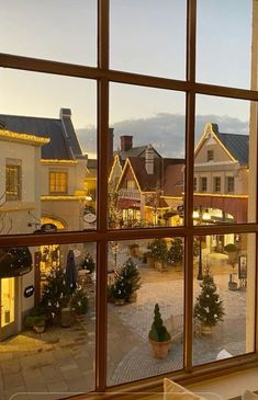 a view out the window of a small town at christmas time