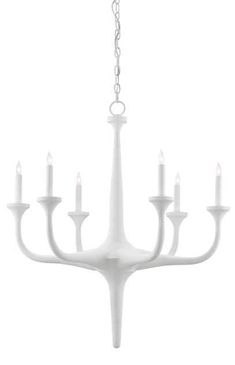 a white chandelier with six lit candles hanging from it's center point