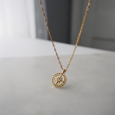 "Finding your path is a personal journey, a dance between self-discovery and the whispers of your heart, leading you to the destination only meant for you." Find your way in style with our Compass Necklace. This playful pendant necklace features a sparkling cubic zirconia center. The perfect accessory for any adventure, it adds a touch of whimsy to any outfit.    -16" in length with 2" extender -stainless steel, gold plated Spiritual Compass Necklace For Gift, Compass Design Necklace Gift, Spiritual Compass Design Necklace As Gift, Spiritual Compass Design Necklace For Gift, Spiritual Compass Design Necklace Gift, Spiritual Compass Pendant Necklace, Everyday Spiritual Round Charm Necklaces, Spiritual Necklaces With Delicate Chain And Round Pendant, Spiritual Necklace With Delicate Chain And Round Pendant