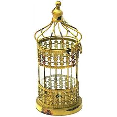 a golden birdcage is sitting on a white surface