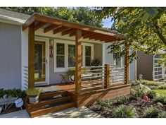 a small house with a wooden porch and white doors