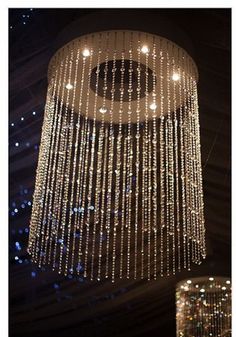 a chandelier hanging from the ceiling in a room with many lights on it