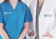 two people standing next to each other wearing blue scrubs and white coats with the words durham dental on them