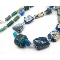 a long necklace with blue and green beads