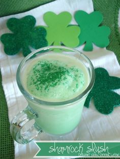 a drink in a glass with shamrocks on the side