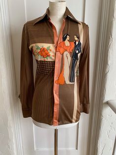 This is a rare collectable Mark Elliot Couture-Sport 100% Nylon vintage 1970's Disco Shirt. Artists signature NEMO Print on front is of a couple of art deco tango dancers or maybe Latin lovers and some roses. The back has the same couple with musical notes and looks like an ampitheatre?  Size label is Small. Underarm to underarm 19 inches. Underarm to underarm to 19 inches.  It is in great vintage condition with no snags, holes or stains. It has the initials AS written in pen on the label. Retro Vintage Print Blouse For Fall, Retro Blouse With Vintage Print For Fall, Fall Retro Blouse With Vintage Print, Retro Graphic Print Blouse For Fall, Retro Fall Blouse With Graphic Print, Brown Retro Top With Vintage Pattern, Vintage Fitted Brown Blouse, Vintage Graphic Print Blouse For Fall, Retro Fitted Brown Blouse