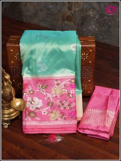 Embrace class with this stunning Banarasi Katan silk saree in hues of light Green and Pink. This opulent, lightweight saree is fully handwoven with Kadwa Silver and Golden zari buttas on the body with resham Meenakari Kadiyal floral border. Set yourselves apart with this saree. Part of the package is an unstitched blouse piece. Silk Mark Certified. Handloom Banarasi Katan silk. Custom handmade tassels adorn the Pallu. Fall and Pico - Done Blouse - Unstitched Please note: Color may vary slightly Luxury Katan Silk Saree With Resham Embroidery, Banarasi Katan Silk Saree, Kora Silk Sarees, Katan Silk Saree, Katan Silk, Traditional Wear, Banarasi Sarees, Green And Pink, Floral Border