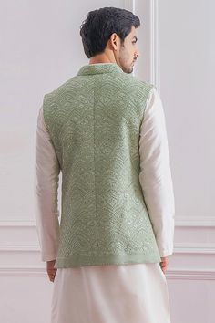 Mint green Lucknowi Nehru jacket with delicate thread and sequins embroidery.
Component: 1
Pattern: Embroidered
Type Of Work: Sequins
Neckline: Mandarin
Sleeve Type: Sleeveless
Fabric: Pure Georgette; Lining: Twill Satin
Color: Green
Other Details: 
Front button down jacket
Note: The kurta and churidar worn by the model is not for sale
Occasion: Mehendi and Haldi - Aza Fashions Nehru Jacket For Men, Kurta Set For Men, Nehru Jacket, Nehru Jackets, Green Sequins, Satin Color, Sequins Embroidery, Churidar, Kurta Set