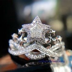 a close up of a diamond ring on top of a wooden table