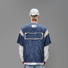 The Deconstructed Patchwork Jersey seamlessly blends street style with athletic aesthetics. Featuring a bold color-block patchwork design, this jersey stands out with its unique look. The left chest sports a branded badge, while the front hem is printed with "Petrichor" and the brand logo. The back is adorned with a thorny leaf patch, adding an extra layer of detail. Made from premium 100% cotton fabric, this jersey ensures both comfort and durability. The oversized fit provides a relaxed, moder Sporty Cotton T-shirt With Patchwork, Sporty Cotton T-shirt With Patchwork Details, Sporty Patchwork Cotton T-shirt, Patchwork Cotton Tops For Streetwear, Cotton Patchwork Top For Streetwear, Urban Cotton Color Block Tops, Urban Cotton Patchwork Tops, Sporty Patchwork Tops For College, Relaxed Fit Patchwork Top For Streetwear