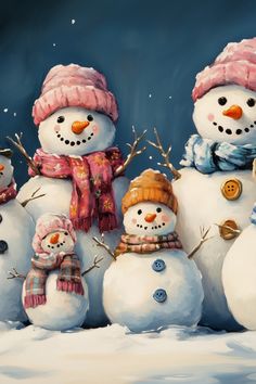 three snowmen with hats and scarves standing next to each other in the snow