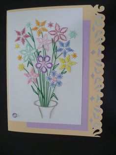 a handmade card with flowers in a vase