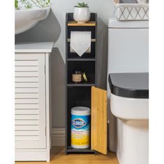 a bathroom with a toilet, sink and shelving unit next to the bathtub