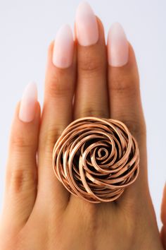 "DON 925's master silversmiths handcrafted this unusual ring with genuine copper. Make a statement with this gorgeous ring. Diameter Size: 3.8 cm (1.50 inches) Ring rises 1.8 cm (0.70 inches) above the finger. Band width: 6 mm (0.23 inches) Weight: 31.2 grams Some people say copper helps ease the aches and pains of stiff and sore joints. These rings are made of genuine solid copper and an alloy metal for soldering (The silver detail you see is evidence of the soldering - Not an imperfection in t Elegant Rose Gold Copper Rings, Handmade Elegant Copper Rings, Unique Handmade Copper Rings, Unique Silver-colored Copper Ring, Unique Silver Copper Ring, Unique Bronze Copper Rings, Handmade Rose Gold Flower Ring, Rose Gold Open Ring In Copper, Rose Gold Copper Open Ring