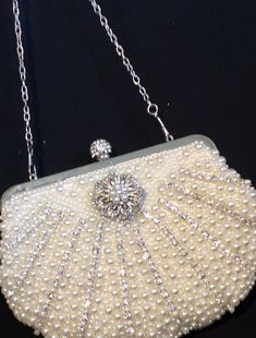 Fabulous design with a glittering touch.  Perfect finishing touch for any formal outfit.  Ideal for cocktail party or wedding.  Can be finished in pearl white.  Measures 6.3 x 9 inches. Elegant White Evening Bag, Luxury Pearl Evening Bag For Party, Elegant Handheld Evening Bag For Wedding, Formal Rectangular Evening Bag With Pearl Handle, Elegant White Handheld Evening Bag, Elegant White Evening Bag With Pearl Handle, Elegant Pearl White Clutch For Events, Elegant White Clutch For Events, Elegant White Clutch For Formal Occasions