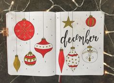 an open notebook with christmas ornaments and the words december written in black ink on it