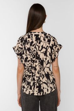 Exquisitely crafted, the Avery Top showcases a flattering V-neck pop-over style complemented by short ruffle sleeves, adding a touch of femininity. The cinched back ensures a comfortable and effortlessly chic fit. Material: 100% Viscose Machine wash cold or hand wash Color: Black Cream Floral Model is 5'9" and wearing a size S Imported Ruffle Sleeves, Effortless Chic, New Tops, Floral Top, Black Cream, Sweater Jacket, Outerwear Jackets, Jacket Outfits, Denim Dress