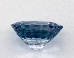 a blue diamond sitting on top of a white surface