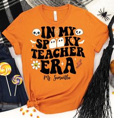 Groovy Halloween Teacher Shirt,Custom Spooky Teacher Shirt,Kindergarten Halloween Teacher Gift,Halloween School Party, Autumn Teacher Shirt(F26-419) ------------------------------------------------------- A B O U T - T H I S - T S H I R T ------------------------------------------------------- Groovy Halloween Teacher Shirt,Custom Spooky Teacher Shirt,Kindergarten Halloween Teacher Gift,Halloween School Party, Autumn Teacher Shirt Available in size : XS, S, M, L, XL, 2XL, 3XL Available in color  * Black * White * Brown * Dark Grey Heather * Red * Heather Kelly * Heather True Royal * Heather Olive * Red * Heather Navy ------------------------------------------------------- F A B R I C A T I O N ------------------------------------------------------- Solid colors are 100% cotton except Ash - Fitted Long Sleeve Halloween T-shirt, Spooky Fitted Tops For Halloween, Spooky Fitted Halloween Tops, Halloween Long Sleeve Shirt With Letter Print, Spooky Halloween Shirt With Letter Print, Fitted Halloween T-shirt With Character Print, Fitted Spooky T-shirt For Fall, Fun Halloween Shirt With Character Print, Halloween Novelty Shirt With Letter Print