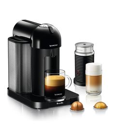 an espresso machine with two cups next to it and three other coffee accessories