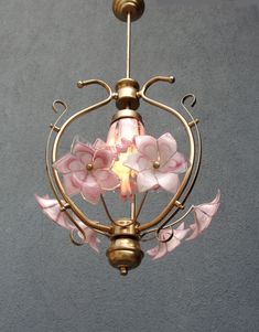 a chandelier with pink flowers hanging from it