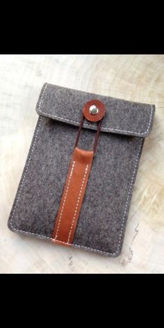 an ipad case with a brown leather strap