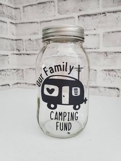 a glass jar with the words our family camping fund written on it and an image of a camper