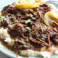 a close up of a plate of food with meat and potatoes