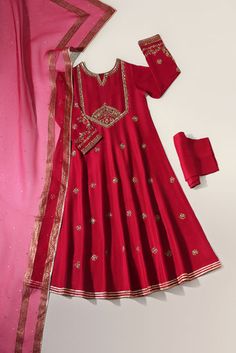 This beautiful three piece is designed on pure fuschia raw silk heavily embellished with pretty hand gotah zardosi ( handwork/ada ) details. Paired with a regal tye dye pure  dupatta with fuchsia pure chundri dupatta with goti phool spray. The length of the panelled pishwas is 48 inches. An alluring three piece for you Festival Silk Salwar Kameez With Dori Work, Silk Salwar Kameez With Dori Work For Festivals, Raw Silk Dupatta With Dabka Work In Traditional Drape, Raw Silk Dupatta With Dabka Work, Raw Silk Choli With Gota Work For Eid, Festive Silk Salwar Kameez With Dori Work, Festive Traditional Wear In Raw Silk With Gota Work, Festive Raw Silk Churidar With Resham Embroidery, Designer Silk Dupatta With Dabka Work