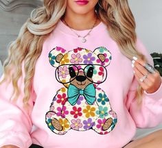 Colorful Daisy Teddy Bear Spring Sweatshirt | Unique Gifts for Family Friends   Embrace the spirit of spring with our vibrant color palette, featuring pastel hues and refreshing tones that capture the essence of nature's awakening. Whether you're strolling through blooming gardens or enjoying a picnic in the park, our crewnecks effortlessly elevate your spring wardrobe. Stay cool and comfy with our spring crewnecks.   Key Features: High-Quality Material: Made from soft and durable fabric, this sweatshirt is built to last and keep you cool and comfy. Unisex Design: This versatile pullover suits all genders, offering a relaxed and comfortable fit. Charming Appeal: Our spring sweatshirts are designed to add a touch of charm to your seasonal attire, making you stand out in style.   Physical At Pink Casual Sweatshirt With Floral Print, Pink Floral Print Casual Sweatshirt, Casual Pink Floral Print Sweatshirt, Cute Green Sweatshirt For Spring, Pink Relaxed Fit Sweatshirt For Spring, Pastel Crew Neck Top For Spring, Pastel Crew Neck Spring Top, Trendy Multicolor Sweatshirt For Spring, Spring Sweatshirt