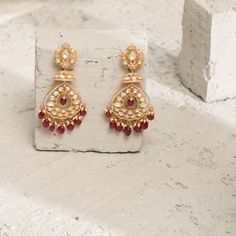 Description: Spark your traditional style with these regal silver dangle earrings from Paksha. Featuring a dazzling moissanite stone on the stud along with CZ intricate, layered with moissanite studded jhumki and chandbali layers. This pair is finished with gold-tone plating and little pearl & ruby bead drops. Wear yours with other moissanite jewelry – these are true favorites. Product Information Materials used: 925 Silver with 1.0-microns Yellow Gold Plating Stones: Semi precious stones Length Kundan Bridal Earrings In Temple Jewelry Style, Kundan Bridal Earrings With Elegant Temple Design, Kundan Temple Jewelry Bridal Earrings, Temple Style Chandelier Earrings For Reception, Traditional Diamond Earrings With Latkans, Traditional Diamond Earrings With Intricate Design, Traditional Diamond Earrings For Wedding And Festive Occasions, Traditional Cubic Zirconia Chandelier Earrings For Festive Season, Traditional Diamond Bridal Earrings For Festivals