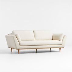 a white couch sitting on top of a wooden frame