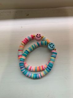 two colorful bracelets with smiley faces on them