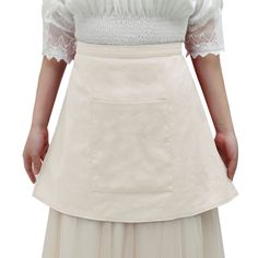 a woman wearing a white skirt with a lace top on her shoulders and an apron over her shoulder