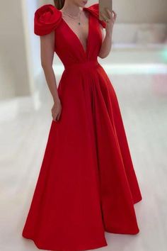 a woman in a red dress is taking a selfie