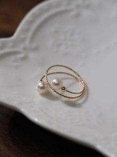 Experience the timeless charm of our 14K Gold-Filled Freshwater Double Pearl Wrapped Wire Ring Elevate any ensemble with its luxurious touch, modern design, adjustable fit, and versatile styling. Make a statement of elegance and sophistication wherever you go. Metal: 14K Gold Filled Gemstone: Freshwater Pearls Pearl Diameter: 5.5-6mm Size: Adjustable 6-8 Weight: 1g Wire Pearl Ring, Double Pearl Ring, Gold Wrap Ring, Pearl Rings, Wire Ring, Wire Rings, Wrap Rings, Pearl Ring, Double Layer