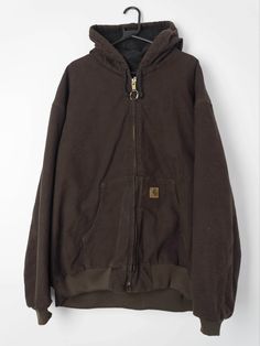 Mens vintage Carhartt hooded dark brown heavy cotton jacket with full zipper and quilted padded lining. Drawstring hood, elasticated hem and cuffs and two front pockets. Circa Y2k. Our recommended size: 4XL Label Says: 4XL Condition: Very Good Material: 100% Cotton shell We've provided garment measurements below and suggest you compare these to a similar garment you own to determine a good fit. Measurements are taken flat and doubled for waist and hip. Information on how we measure our jeans (wh Vintage Carhartt, Mens Vintage, Cotton Jacket, Heavy Cotton, Dark Brown, Zipper