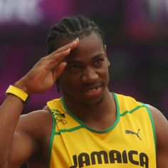 a man with dreadlocks is holding his head