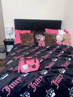 a black and pink bed with hello kitty on it