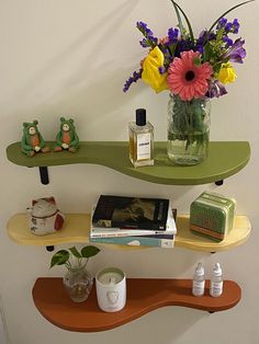 two shelves with flowers and books on them