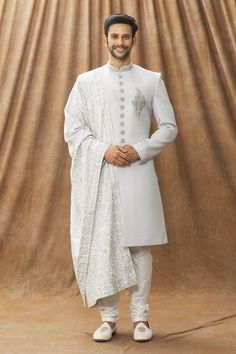 Grey art silk sherwani with placement floral motif and mandarin collar. Comes with churidar and stole.
Component: 3
Type Of Work: Floral pattern
Neckline: Mandarin
Sleeve Type: Full sleeves
Fabric: Sherwani and Stole: Art Silk, Pant: Dupion Art Silk, Lining: Faux Satin
Color: Grey
Other Details: 
Front buttons
Floral motif
Occasion: Destination Wedding - Aza Fashions Grey Sherwani, Stole For Men, Silk Stoles, Grey Art, Satin Color, Fashion App, Churidar, Grey Floral, Full Sleeves