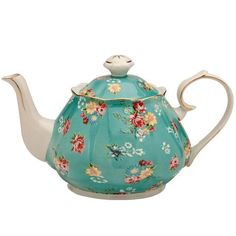 a tea pot with flowers painted on it