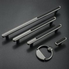 an assortment of door handles and knobs on a black surface with a circular handle